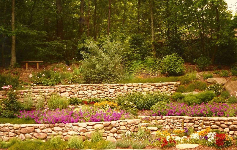 River rock stone wall terraces perennials